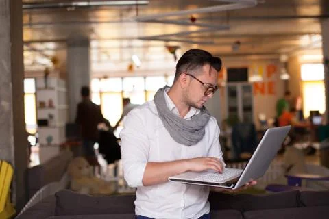 Stylish man using smartphone in startup office Stock Photos