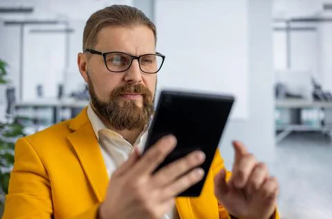 Stylish man using tablet at office Stock Photos