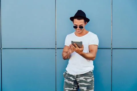 Stylish man using a tablet outdoors. Stock Photos