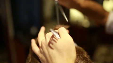 A stylish men cut his beard and hair in the barbershop Stock Footage 73871658