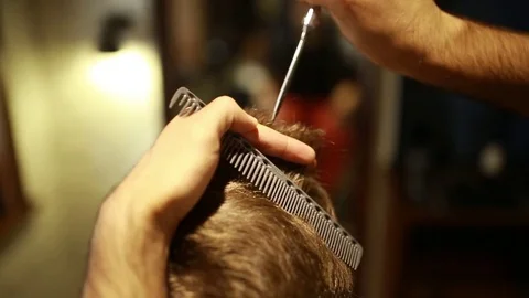 A stylish men cut his beard and hair in the barbershop Stock Footage 73871671