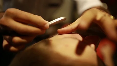 A stylish men cut his beard and hair in the barbershop Stock Footage 73871674