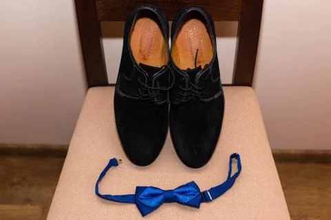 Stylish men's black shoes and the bow tie. Close up of modern man accessories. Stock Photos