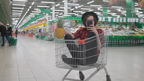 Stylish millennial hipster boy having fun at the grocery store, attractive young Stock Footage 125101006