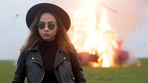 Stylish model against the background of an exploding car, girl and exploding car Stock Footage 95193260