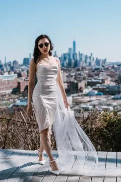 Stylish Model Dressed Elegantly Poses Against a Beautiful City Skyline Backdrop Stock Photos