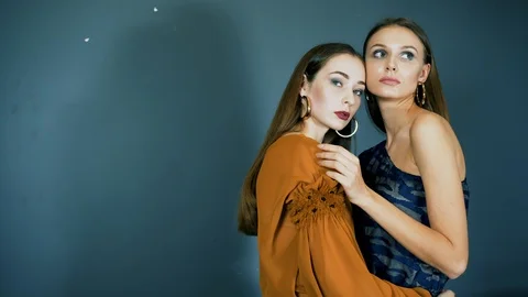 Stylish models with earrings in ears and with bright makeup close-up together Stock Footage 93542278