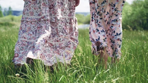 Stylish models showcase walking dresses in a serene outdoor setting Stock Footage 310264591