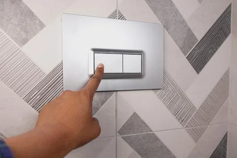 Stylish Modern Bathroom Tile Featuring a Convenient Toilet Flush Button for Easy Stock Photos