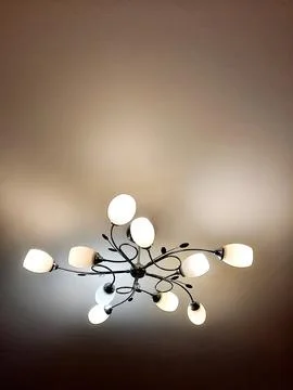 Stylish modern ceiling light fixture in home interior Stock Photos