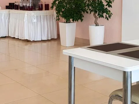 Stylish modern interior of the dining room with tables and chairs, lots of glass Stock Photos