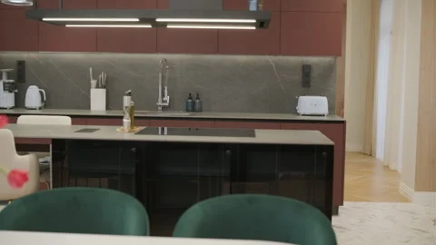 Stylish modern kitchen with red cabinets, a marble backsplash Stock Footage 270093329