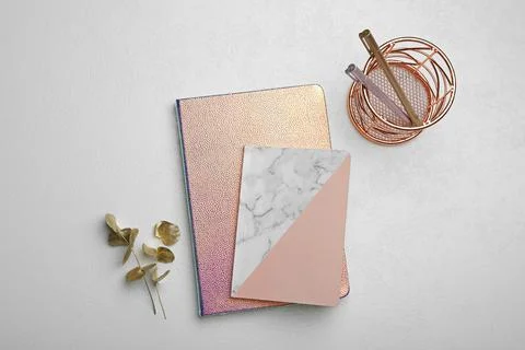 Stylish notebooks and decor elements on white table, flat lay Stock Photos
