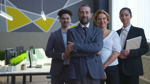 Stylish office team, workers in suits, men and women looking at camera smiling Video stock 233993982