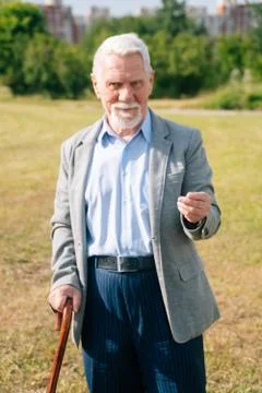 Stylish old man asks to give money. Portrait of long old merry European grand Stock Photos