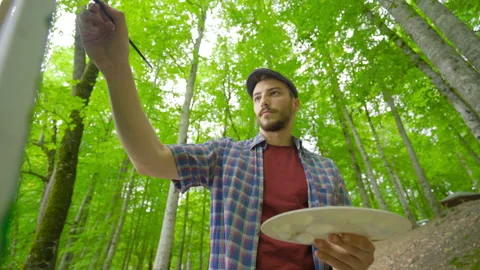 The stylish painter paints on canvas. Stock Footage 212282319