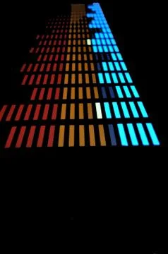 Stylish panel of pixels, neon with blue or green, yellow, red, equalizer in dark Stock Photos