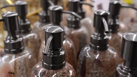 Stylish plastic bottles with a dispenser for liquid soap on a store shelf. Stock Footage 232984174