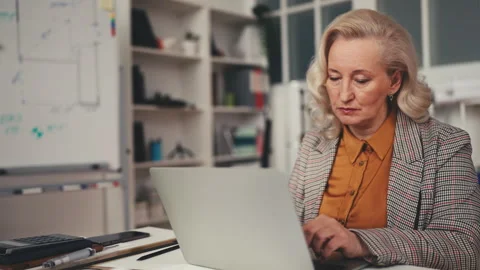 Stylish real estate developer communicating with contractors using laptop, job Stock Footage 251858463