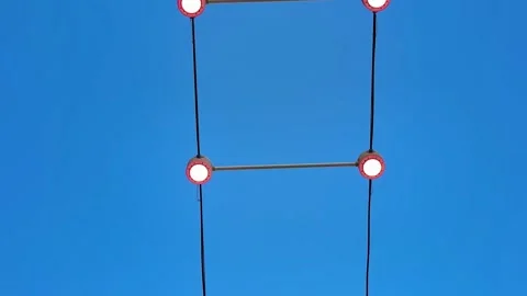 Stylish Red Lights Set Against a Beautifully Clear Blue Sky on a Bright Summer Stock Footage 305362240