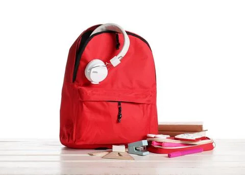 Stylish red school backpack with different stationery supplies and headphones Stock Photos