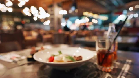 Stylish restaurant table setting with blurred background. Table holds plate Stock Footage 292541607