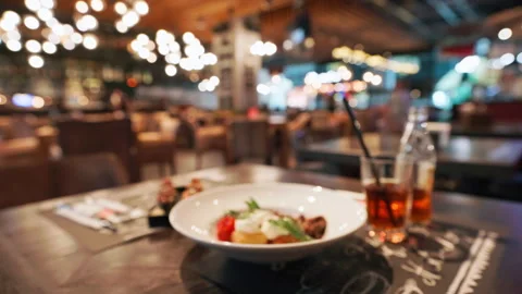 Stylish restaurant table setting with blurred background. Table holds plate Stock Footage 292542681