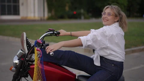 A Stylish Rider Posing Confidently on Their Custom Motorcycle for a Striking Stock Footage 312981703