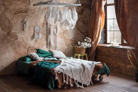 Stylish room interior with large comfortable bed. Beige and white dream catch Stock Photos