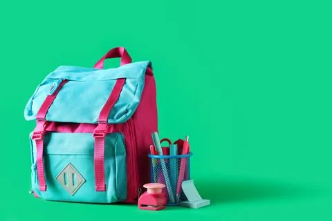 Stylish school backpack and different stationery on green background Stock Photos