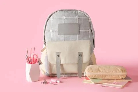 Stylish school backpack and different stationery on pink background Stock Photos
