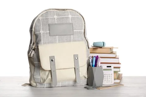 Stylish school backpack with different stationery supplies on wooden table ag Stock Photos
