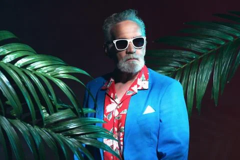 Stylish Senior Businessman between Palm Leaves Stock Photos