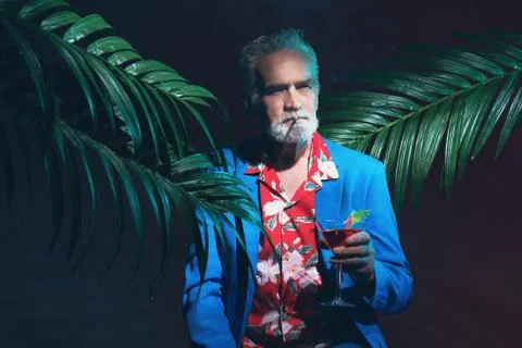 Stylish Senior Man with Cocktail Between Plants Stock Photos
