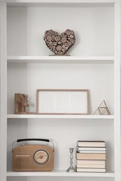Stylish shelves with different decor elements. Interior design Stock Photos