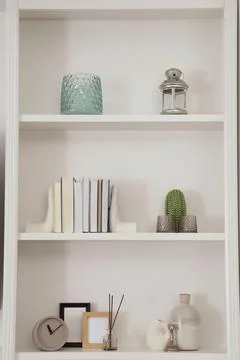 Stylish shelves with different decor elements. Interior design Foto stock