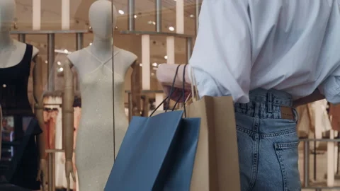 Stylish Shopper Browsing Mall Storefront Stock Footage 311886699