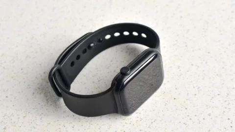 Stylish smartwatch in close-up on a white surface, showcasing modern design.. Stock Footage 261097283