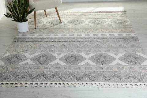 Stylish soft rug with pattern on floor in living room Stock Photos