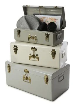 Stylish storage trunks with map, hat and camera on white background. Interior Stock Photos