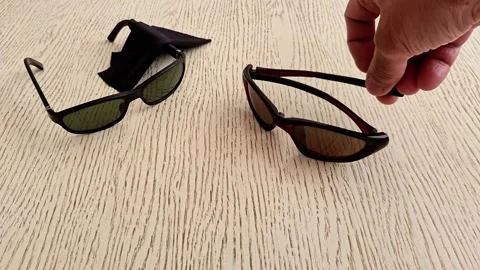 Stylish Sunglasses Displayed on Textured Surface in Indoor Setting Stock Footage 337218511