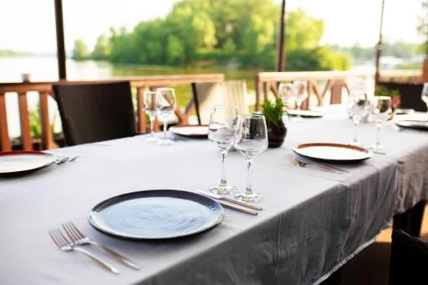 Stylish table setting in an open-air restaurant. Stock Photos