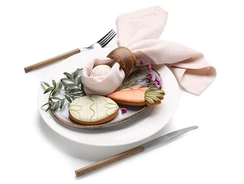 Stylish table setting with sweet cookies, Easter egg and beautiful flowers on Stock-Fotos