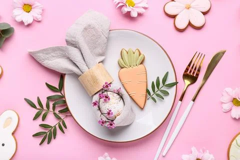 Stylish table setting with sweet cookies, Easter egg and beautiful flowers on Stock Photos