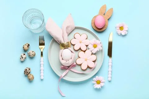 Stylish table setting with sweet cookies, Easter eggs and beautiful flowers o Stock Photos