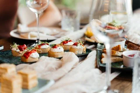 A stylish table setup with gourmet appetizers and elegant finger foods, perfect Stock Photos