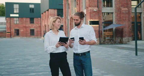 Stylish two business partner walking talking. Business couple talking about work Stock Footage 205852985