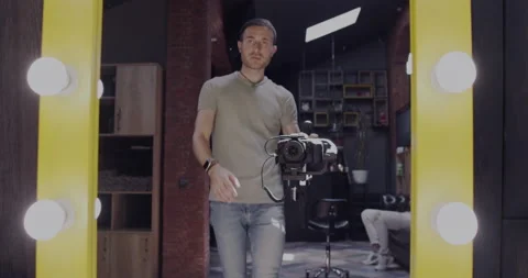 A stylish videographer man with a camera and a mirror. Video stabilizer. Stock Footage 152041402