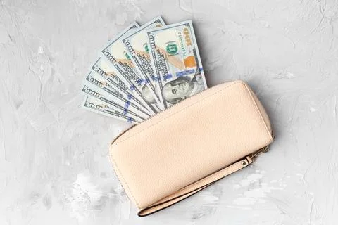 Stylish wallet with 100 dollars banknotes on a light gray background, top vie Stock Photos