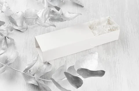 Stylish white blank open rectangle gift box with paper filler mock up on wood Stock Photos